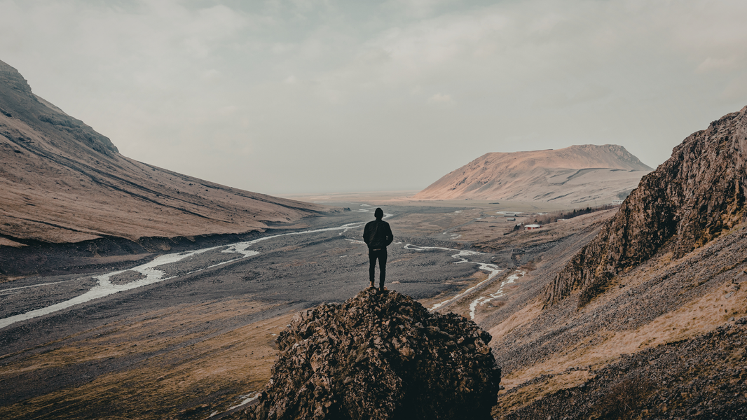 Man standing alone on mountain ridge at sunrise looking out over vast layered valley — NO&YO Voice pillar — How the Man Who Got Lost on Purpose Found His Conviction