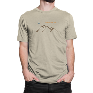 Male model wearing NO&YO “Live to Explore” natural tan t-shirt with minimalist mountain and compass design.