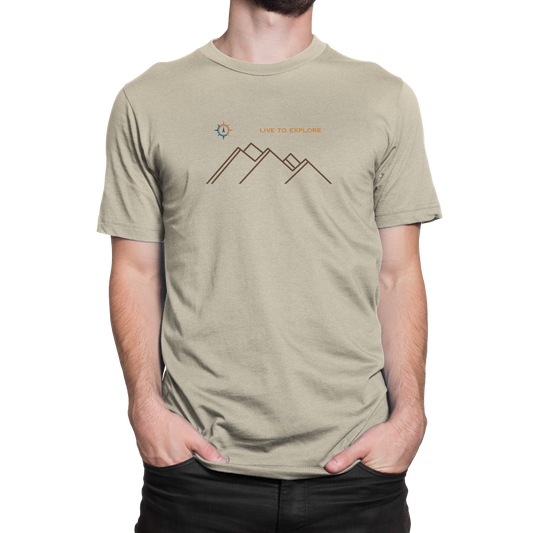 Male model wearing NO&YO “Live to Explore” natural tan t-shirt with minimalist mountain and compass design.