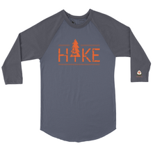 Load image into Gallery viewer, Hit the trails in style with the NO&amp;YO HIKE Adventure Raglan Tee. Featuring a bold distressed “HIKE” graphic with a tree design, this 3/4 sleeve baseball-style shirt is perfect for outdoor lovers who want both comfort and edge. Made with soft, breathable cotton blend fabric, it’s designed for durability whether you’re on a weekend hike, camping, or relaxing fireside. The contrasting charcoal sleeves and heather grey body give it a modern outdoor look, while the curved hem adds extra comfort and mobility.
