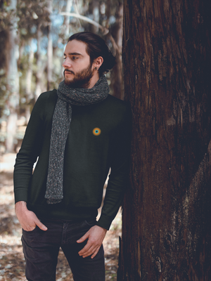 Model in NO&YO Heather Black crewneck sweatshirt with scarf, standing in woods, premium adventure lifestyle clothing.