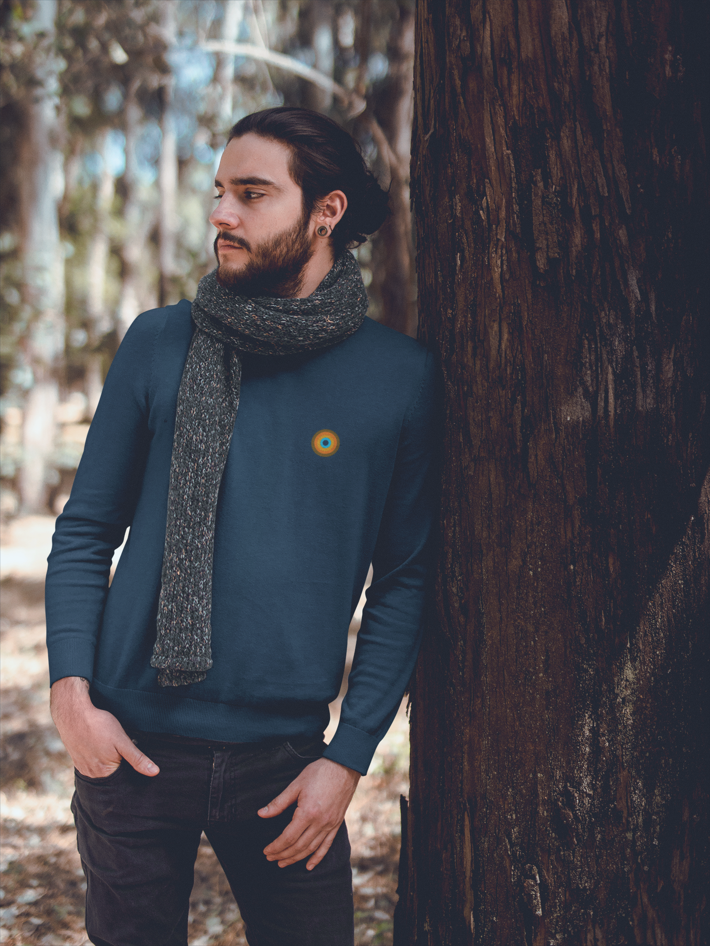Man wearing NO&YO Heather Midnight Navy crewneck sweatshirt styled with scarf in forest setting.