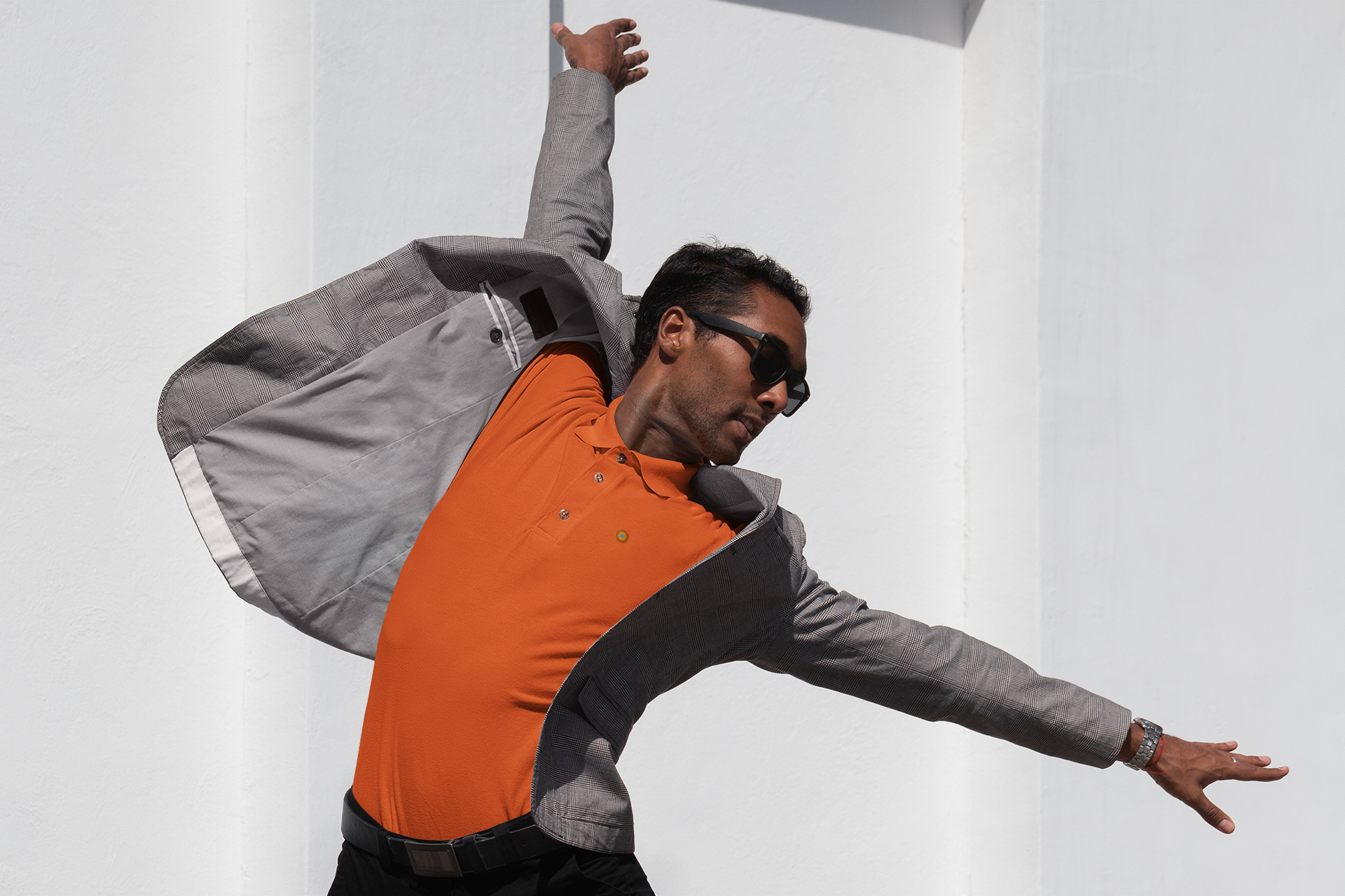 Image showing a model wearing NO&YOs classic polo in orange. 