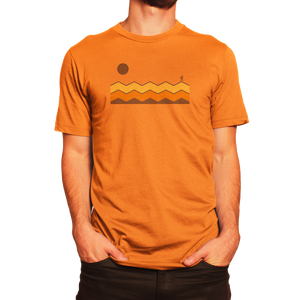 Front view of NO&YO orange Solo Traveler tee with sun and mountain trail graphic.