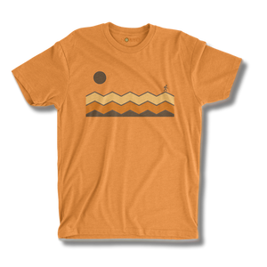 Orange t-shirt with a graphic design of mountains and a sun on a white background