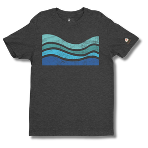 Gray t-shirt with blue and green wavy design on a white background