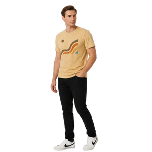 Angled view of the NO&YO Canyon Flow Tee in sand with retro-inspired canyon graphics and modern outdoor lifestyle styling in a bright studio.
