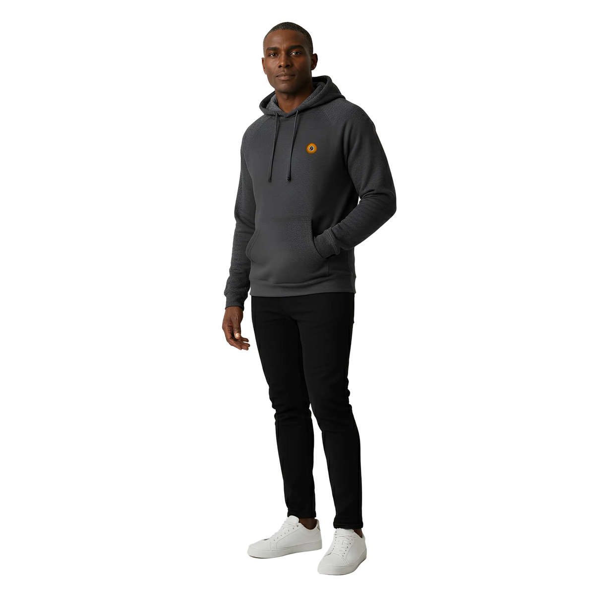 Man wearing a dark gray hoodie with a small logo, black pants, and white sneakers on a light gray background