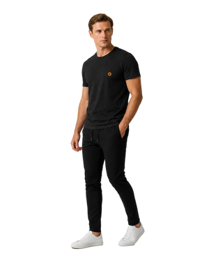 NO&YO men’s Basecamp Black embroidered badge t-shirt, angled studio model wearing premium modern explorer apparel.