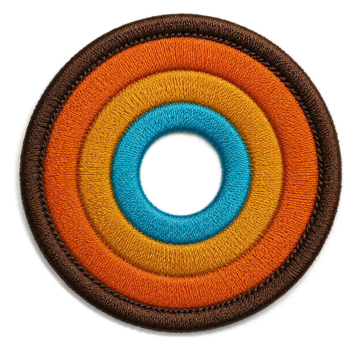 NO&YO embroidered sunset badge logo featuring concentric adventure-inspired rings in brown, orange, gold, and blue.