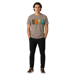 Men’s Ridgeline Tee premium mountain graphic t-shirt in Summit Stone featuring retro color panel mountain artwork, worn by male model in studio setting.