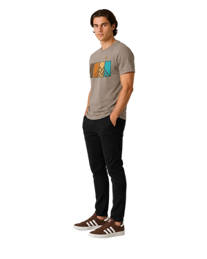 Side view of men’s Ridgeline Tee premium mountain graphic t-shirt in Summit Stone with geometric mountain and color panel design worn by male model.